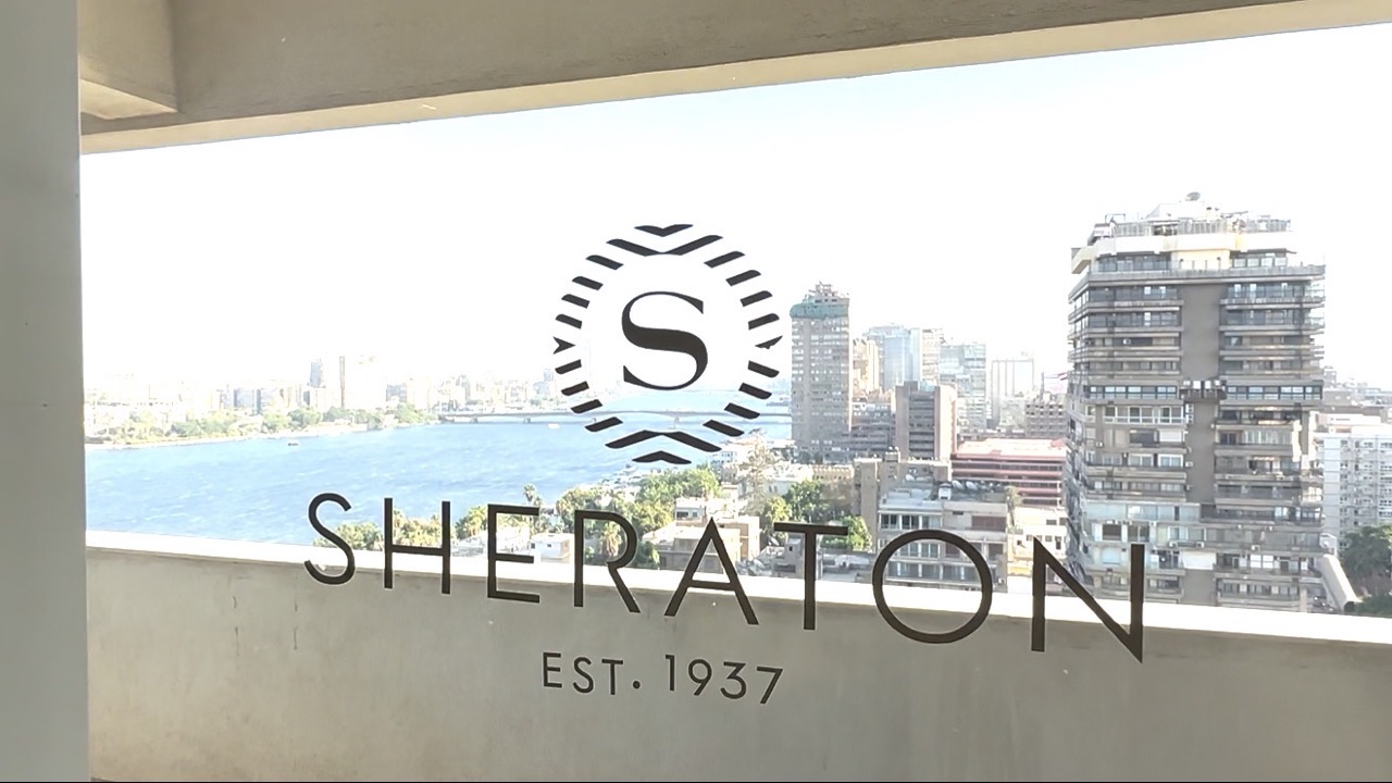 客室の窓ガラスに刻まれたSHERATONロゴ越しのナイル川とカイロ市街地
